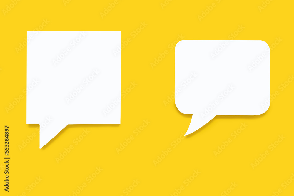 Paper speech bubbles of different shapes on a yellow background. Flat white chat icons in the form of empty speech bubbles. Free space for text or image. The concept of communication in the modern wor Paper speech bubbles of different shapes on a yellow background. Flat white chat icons in the form of empty speech bubbles. Free space for text or image. The concept of communication in the modern wor