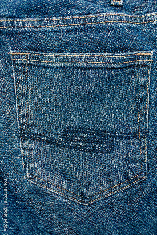 Blue trendy jeans close-up with back pocket view. Denim background and fabric texture. Free space for text. Wide leg indigo jeans. Close-up of the back pocket of jeans in a vertical image Blue trendy jeans close-up with back pocket view. Denim background and fabric texture. Free space for text. Wide leg indigo jeans. Close-up of the back pocket of jeans in a vertical image