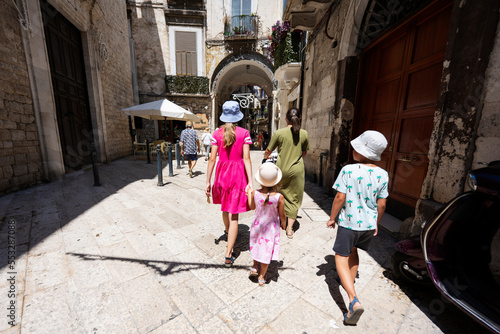 Family of tourists waking in streets Bari, Puglia, South Italy. © AS Photo Family