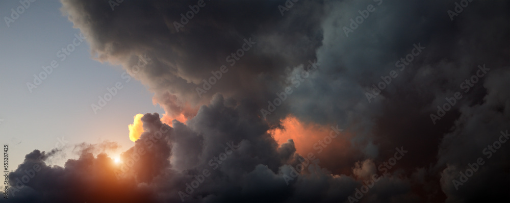 Panorama of dark clouds at sunset time