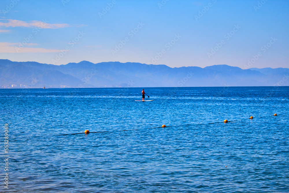 man in paddle board doing sup in the sea, puerto vallarta jalisco 