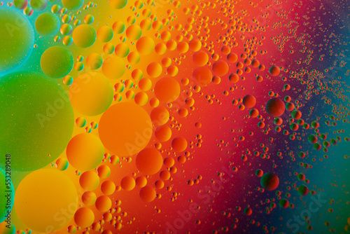 Macro photography of the oil drops on the water surface.Cosmic circles looks like molecule structure.Backdrop with copy space,good as template.
