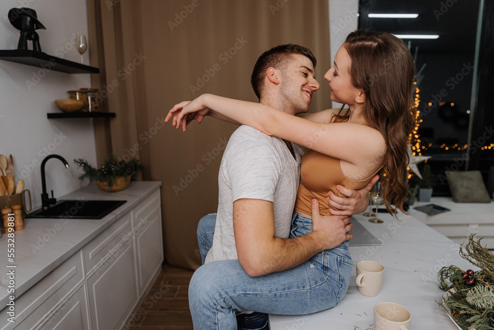 Loving young couple hugging in the kitchen