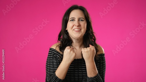 Portrait of excited young woman 20s anticipate great success  winner  isolated on pink background.