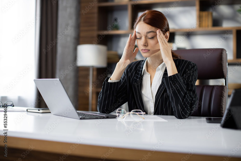 Stressed puzzled caucasian red hair businesswoman with closed eyes feeling headache, sitting in office, exhausted upset employee reading bad news in email, having problem with difficult online project Stressed puzzled caucasian red hair businesswoman with closed eyes feeling headache, sitting in office, exhausted upset employee reading bad news in email, having problem with difficult online project