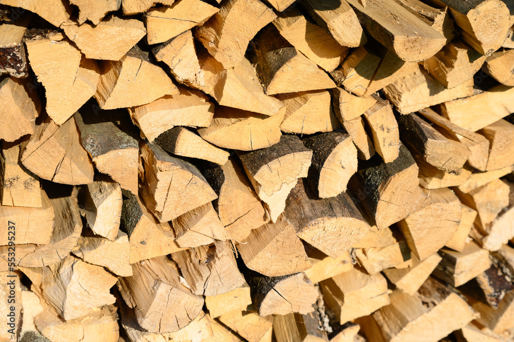Woodpile lies in a heap, chopped for burning in a furnace. Finely chopped and stacked firewood, background. Laid dry firewood, texture, background. Firewood wall, dry chopped firewood background. Woodpile lies in a heap, chopped for burning in a furnace. Finely chopped and stacked firewood, background. Laid dry firewood, texture, background. Firewood wall, dry chopped firewood background.