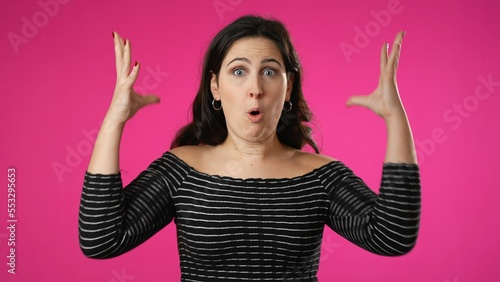 Billede på lærred Attractive thinking young woman 20s, looks at camera gives mind blown gesture showing explosion of ideas posing on pink background