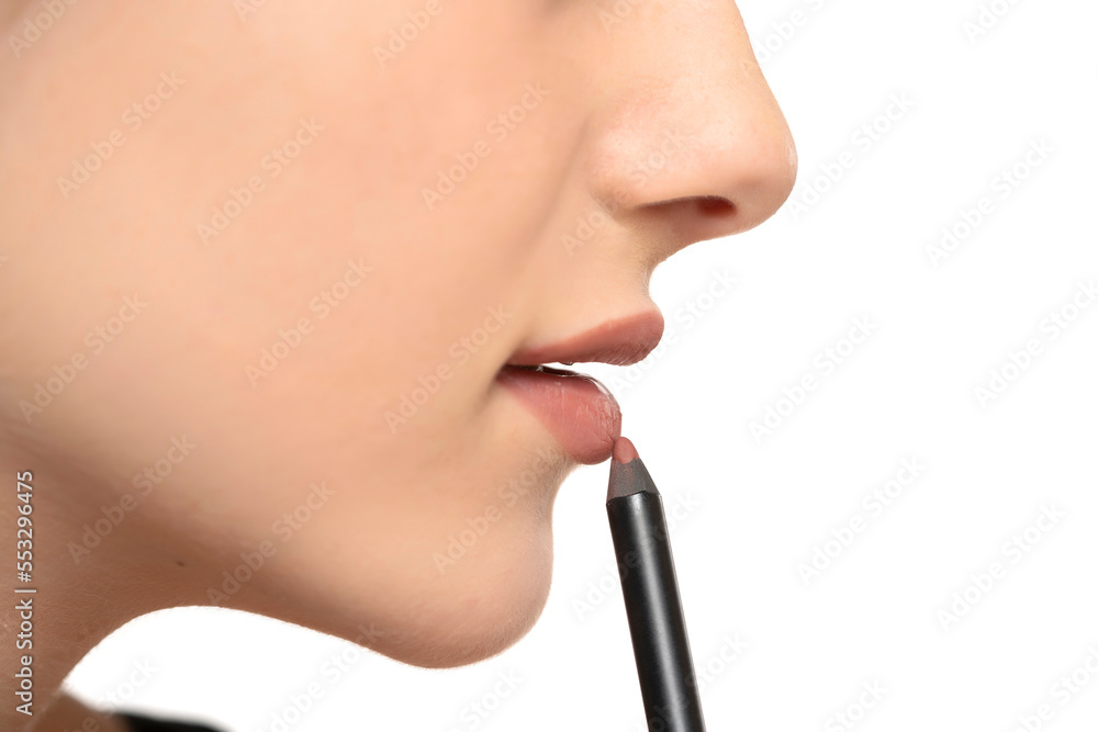 Lips of beautiful young woman applying makeup
