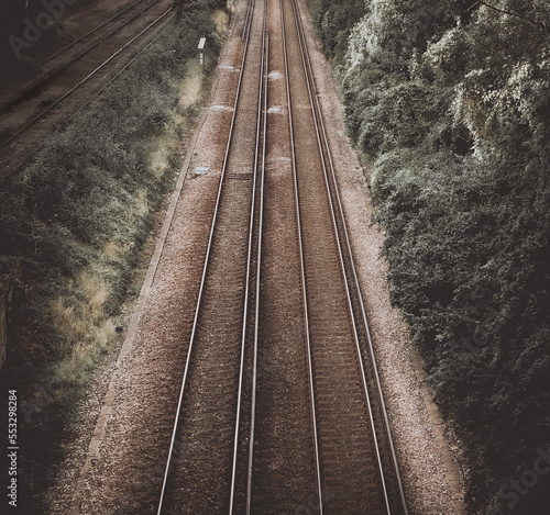 Railway double tracks in the countryside for a dark background presentation linked to movement and transportation for strong business success.