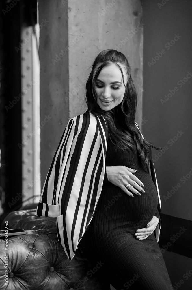 Beautiful young pregnant woman in black dress Beautiful young pregnant woman in black dress
