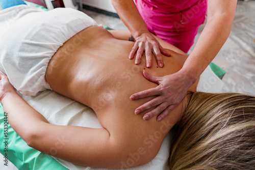Body massage and spa treatment in modern salon, relaxing body massage, closeup