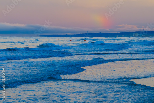 Landscape with rough sea and small rainbow - sea waves
- 