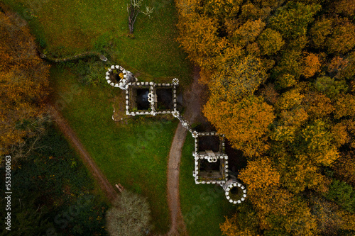 Aerial top down view of Ireland's Ballysaggartmore Towers . Medieval entrance in the forest, Lismore, County Waterford.
