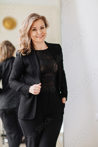 a beautiful and confident woman in a black suit. 