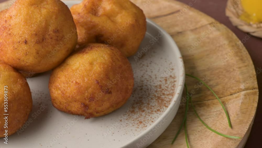 Traditional portuguese Christmas sweets Sonhos with sugar and cinnamon on kitchen countertop. Traditional portuguese Christmas sweets Sonhos with sugar and cinnamon on kitchen countertop.