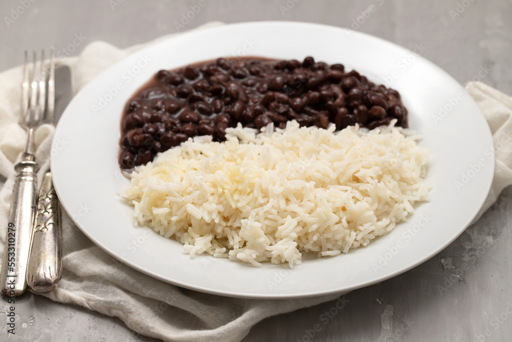 Black beans and boiled rice on white dish. Black beans and boiled rice on white dish.