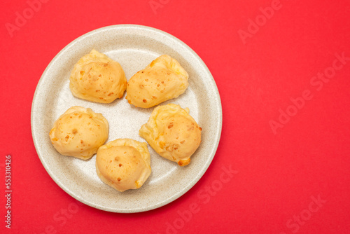 Brazilian snack pao de queijo cheese bread on white dish