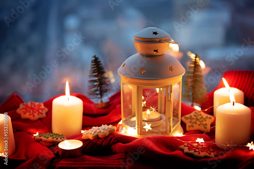 Winter Christmas holidays background with candles  christmas light  Cup of cocoa with marshmallow or hot chocolate near a window