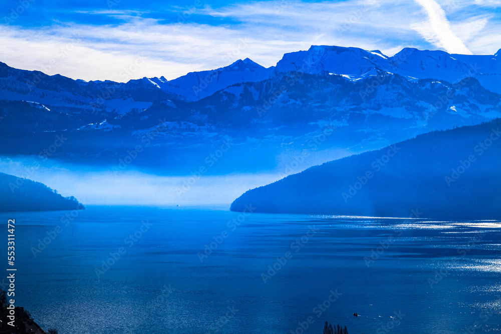 Swiss Alps panoramic skyline misty view over lake Lucern Switzerland Swiss Alps panoramic skyline misty view over lake Lucern Switzerland
