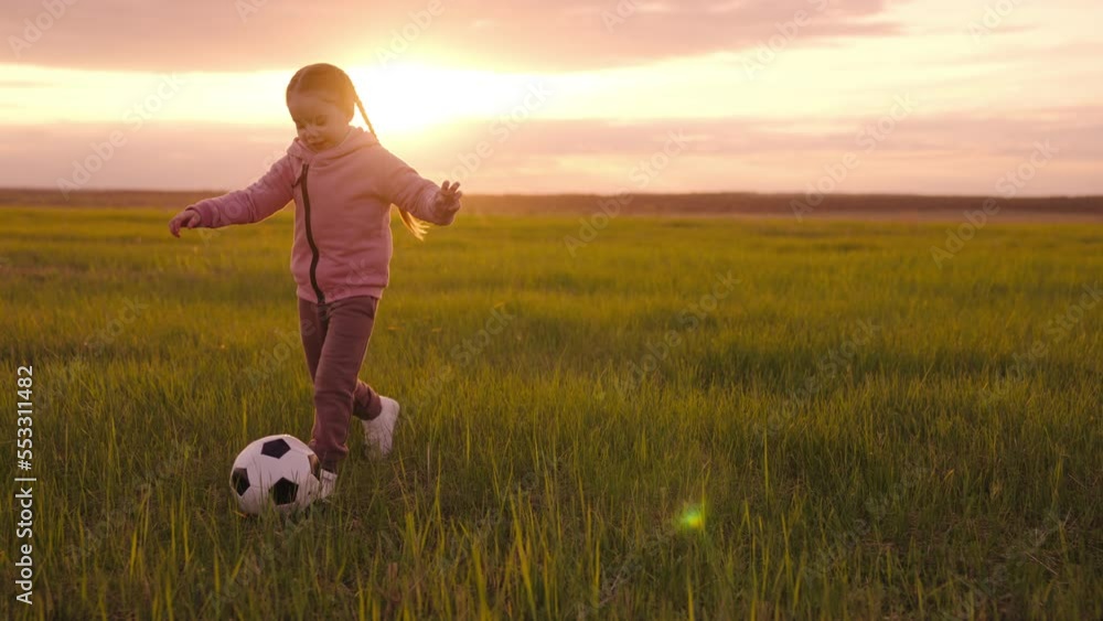 Little Girl Kicks Soccer Ball Green Lawn With Her Foot Small Child little-girl-kicks-soccer-ball-green-lawn-with-her-foot-small-child