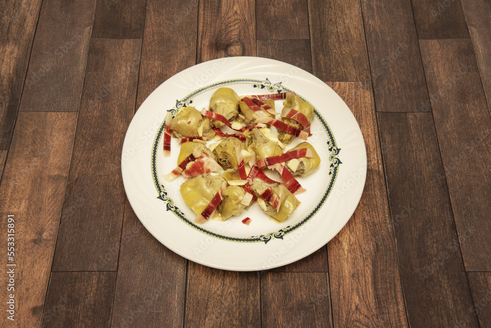 A Spanish tapa of fried artichoke hearts with strips of serrano ham A Spanish tapa of fried artichoke hearts with strips of serrano ham