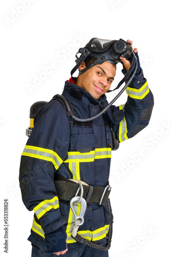 Young smiling African-American fireman in uniform and with air breathing apparatus takes off protective mask from his head. Isolated om white background
