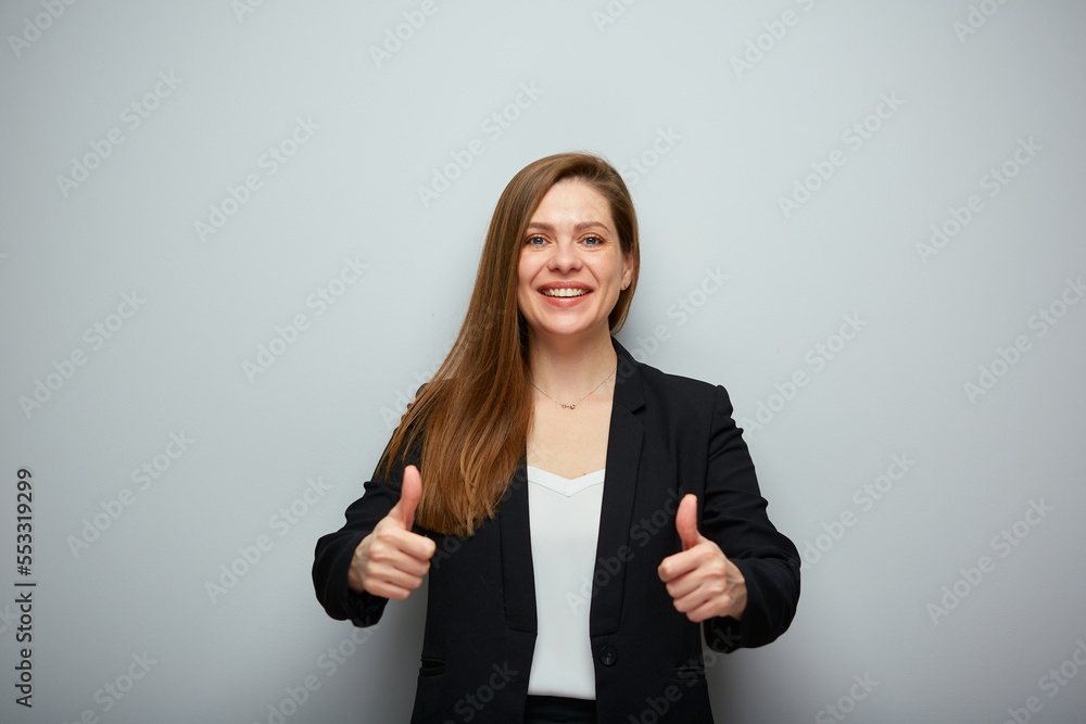 Smiling business woman in black suit with two thumbs up, isolated portrait. Smiling business woman in black suit with two thumbs up, isolated portrait.