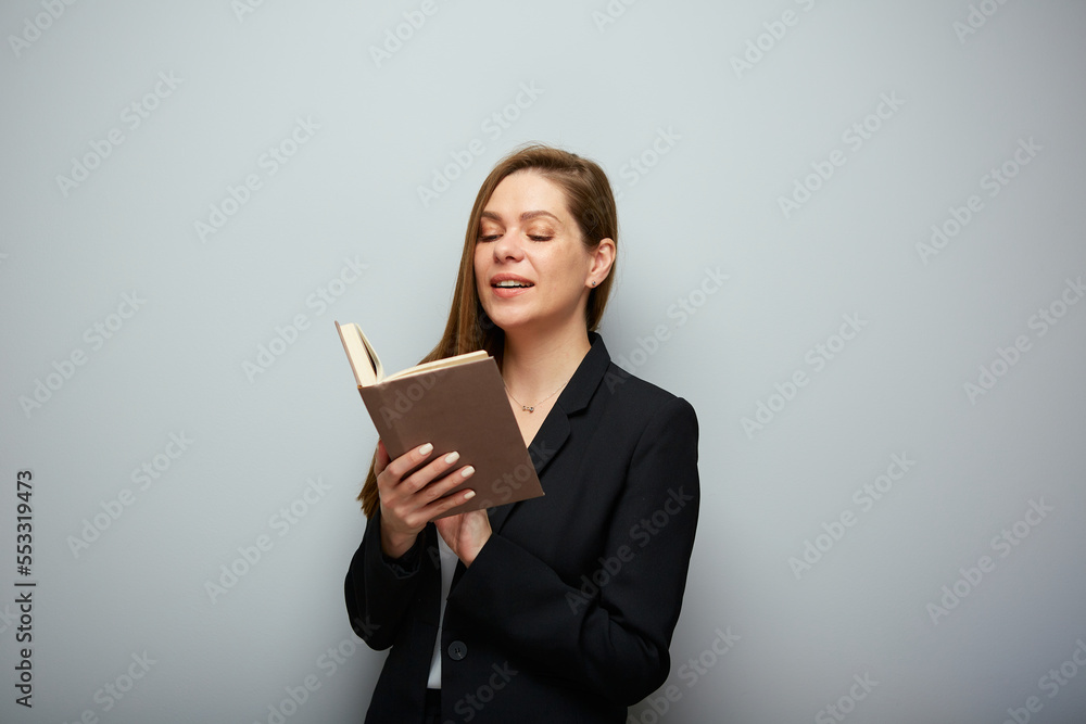 Smiling woman teacher reading book. Isolated portrait with copy space. Smiling woman teacher reading book. Isolated portrait with copy space.