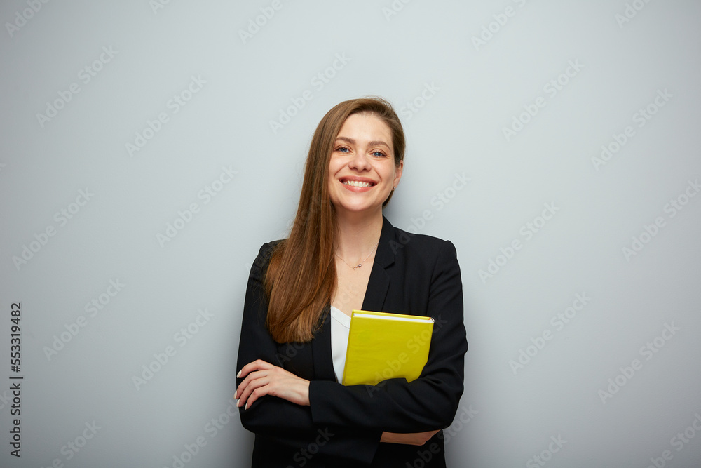 Woman teacher holding yellow book. Isolated portrait with copy space. Woman teacher holding yellow book. Isolated portrait with copy space.