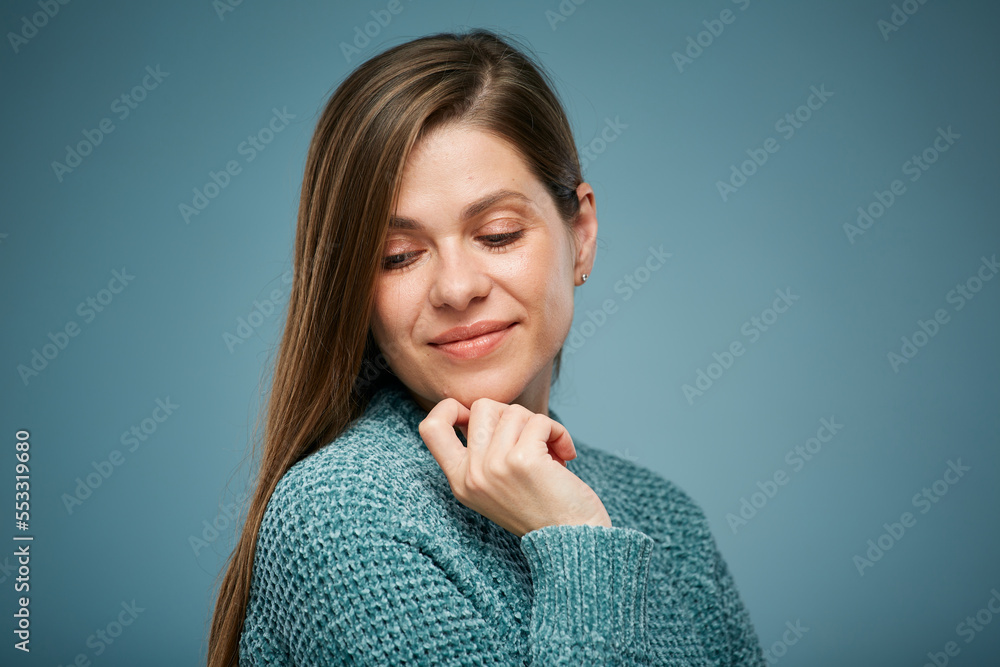 Beautiful smiling woman touching face and looking down. Isolated female face close up portrait Beautiful smiling woman touching face and looking down. Isolated female face close up portrait