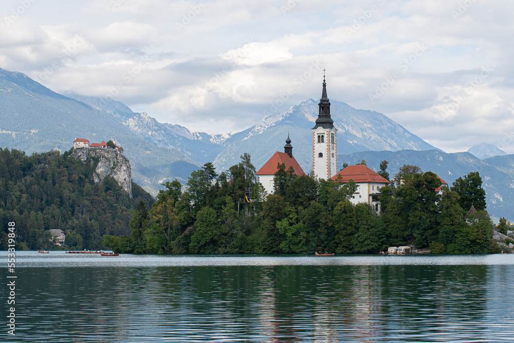 view of bled lake the church of mary assumption and the mountains