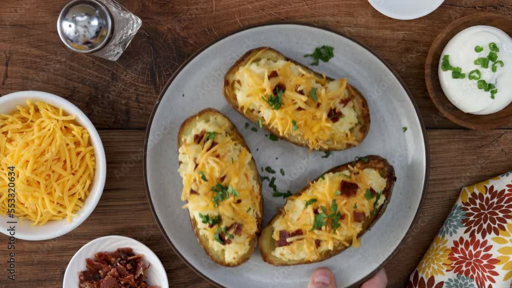 Serving a Plate of Twiced Baked Potatoes Serving a Plate of Twiced Baked Potatoes