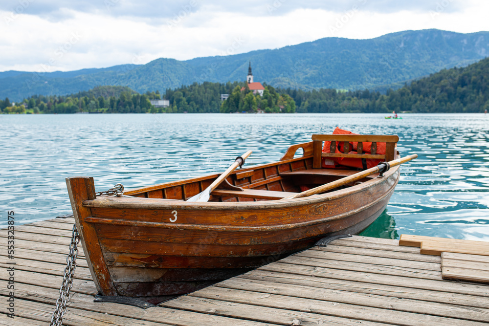 wooden rowing boat at the pier of lake bled