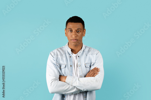 Serious calm confident handsome young african american male student with crossed arms on chest