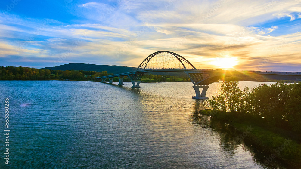 Bridge at sunset with blue skies over water connecting New York to Vermont Bridge at sunset with blue skies over water connecting New York to Vermont