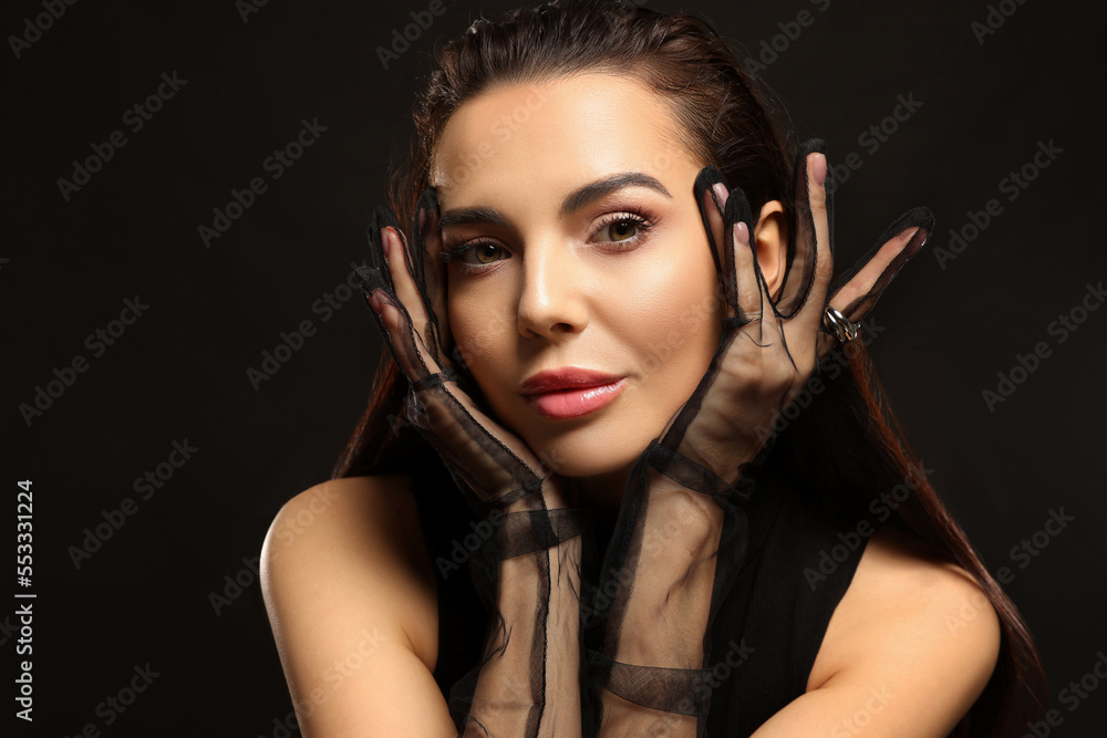 Portrait of beautiful young woman in elegant evening gloves on black background Portrait of beautiful young woman in elegant evening gloves on black background