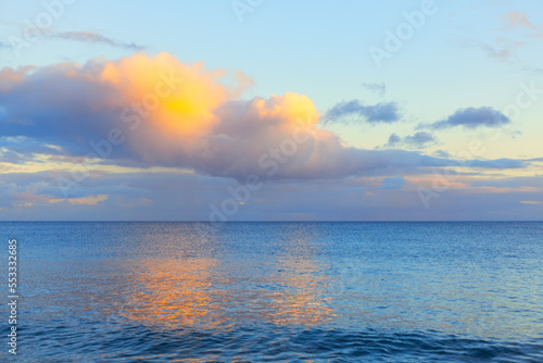 Colorful clouds over the ocean . Twilight reflection in the seawater