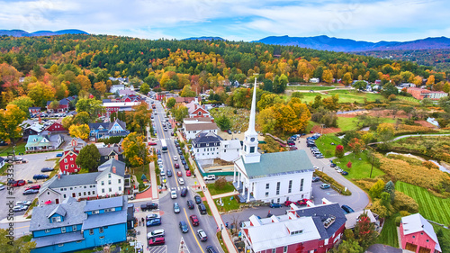 Photography Beautiful aerial view over small Vermont town of Stowe in peak fall foliage with