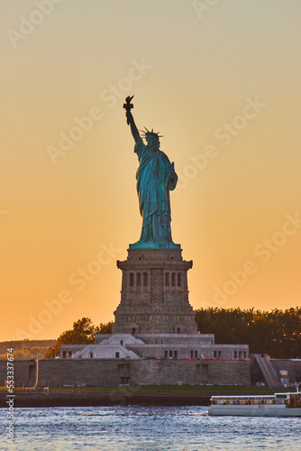 New York City golden hour light around iconic Statue of Liberty in dusk © Nicholas J. Klein