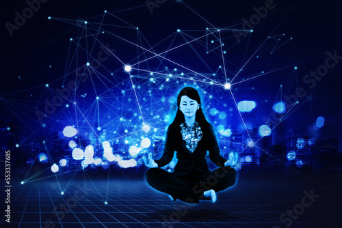 Businesswoman doing yoga exercise in cyberspace