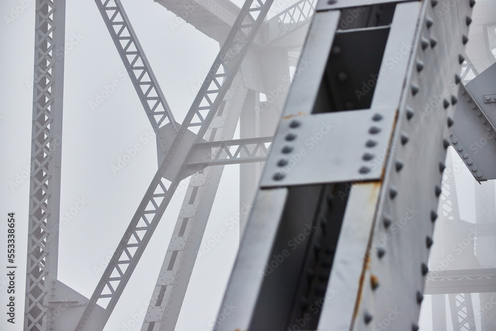 Fototapeta premium Foggy morning detail of steel beams on bridge