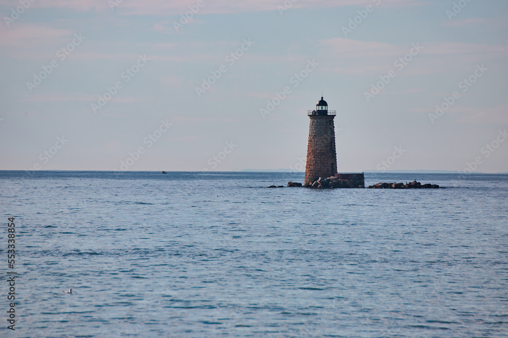 Lone lighthouse on broken rocks in Maine