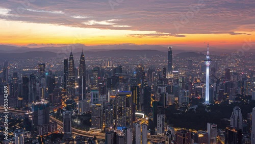 Wallpaper Mural Aerial high angle colorful sunrise time lapse with busy streets overlooking Kuala Lumpur skyline from night to day in KL, Malaysia. Zoom out motion timelapse. Prores 4KUHD Torontodigital.ca