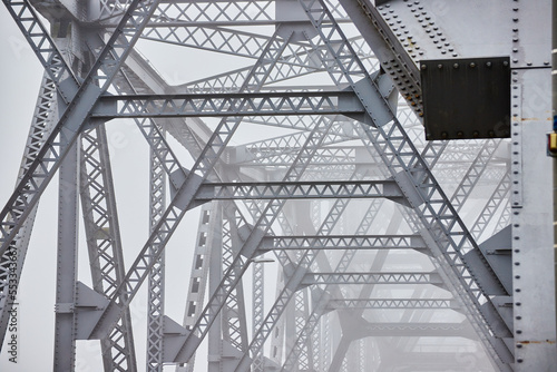 Inner top of old steel bridge fading in foggy morning © Nicholas J. Klein