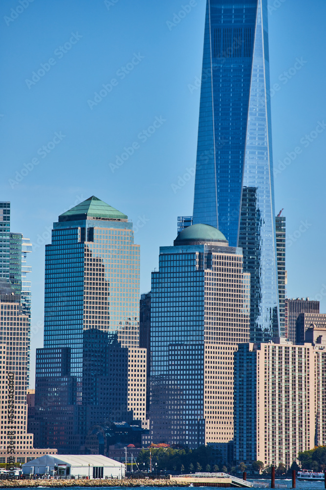 Detail of New York City skyscrapers vertical with reflective glass and blue sky