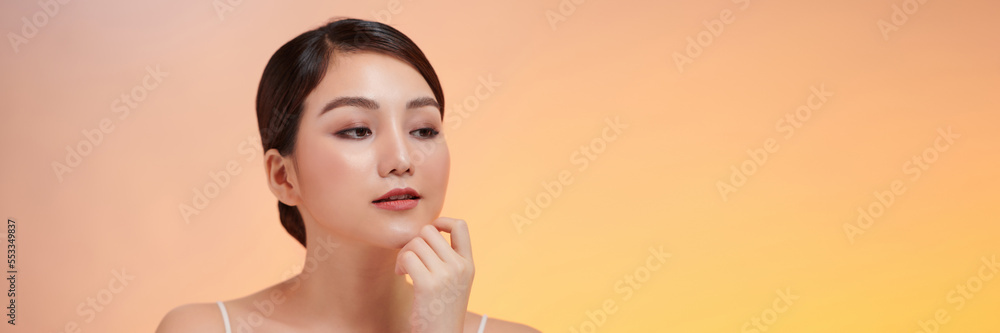Beautiful Young Asian Woman Looking While Touching Chin feeling so happy and cheerful with healthy Clean and Fresh skin Beautiful Young Asian Woman Looking While Touching Chin feeling so happy and cheerful with healthy Clean and Fresh skin