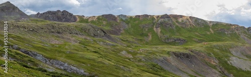Tundra hillside in the tall summer mountains with overcast skies 