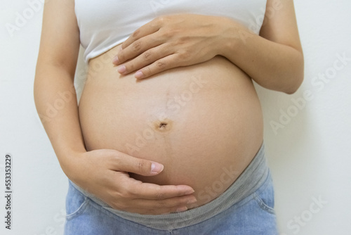 Close up belly pregnant woman wear tank top © Suksan