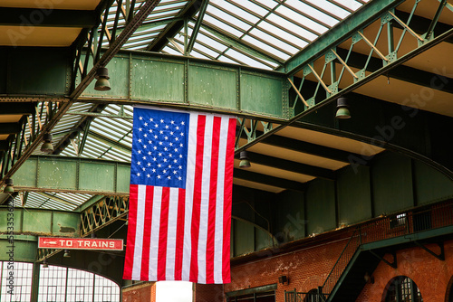 American flag hangs from steel open ceiling in train station of New Jersey photo