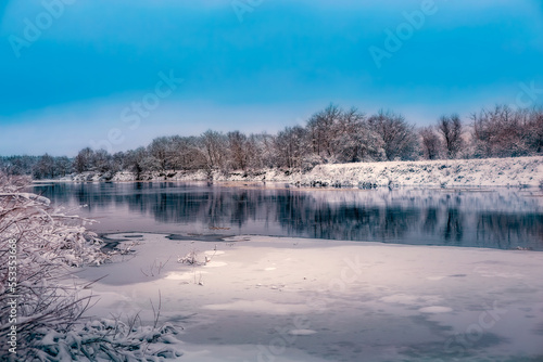 river in winter on the banks of the snow